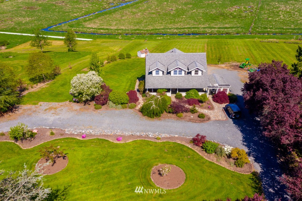 6815 Skipley Road Snohomish, WA 98290 - Photo 1 of 36 a view of a lake with a building in the background