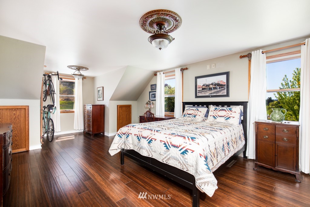 6815 Skipley Road Snohomish, WA 98290 - Photo 17 of 36 a bedroom with bed and a chandelier
