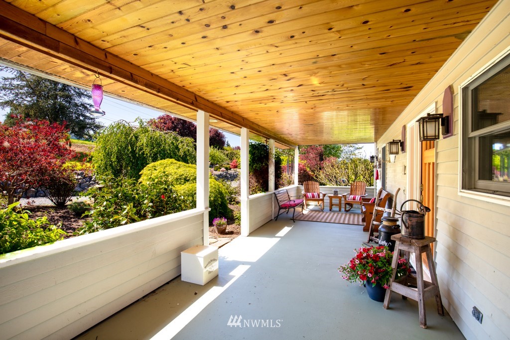 6815 Skipley Road Snohomish, WA 98290 - Photo 6 of 36 a view of a porch with furniture and front view of a building