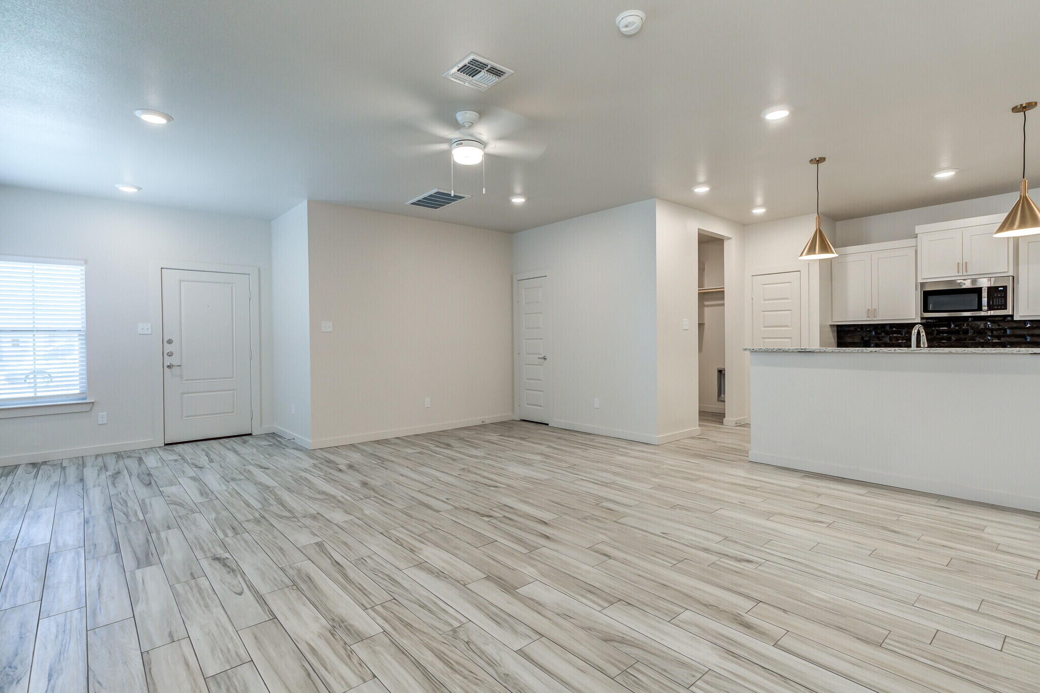 7030 41st Street Lubbock, TX 79407 - Photo 11 of 44 a view of an empty room with kitchen appliances and a window