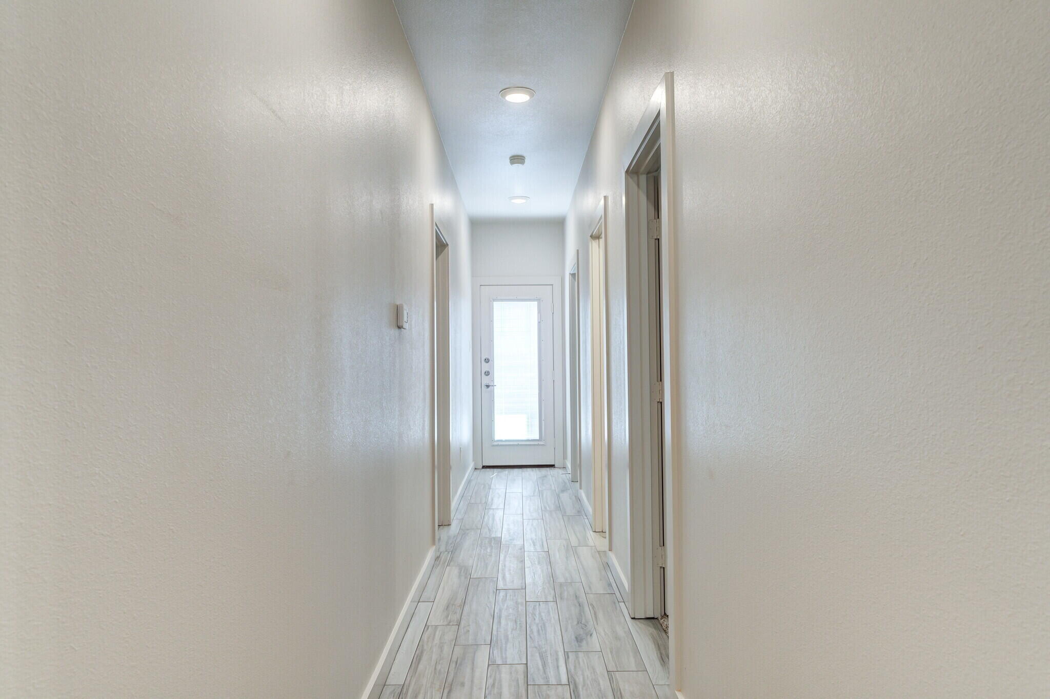 7030 41st Street Lubbock, TX 79407 - Photo 26 of 44 a view of a hallway with wooden floor