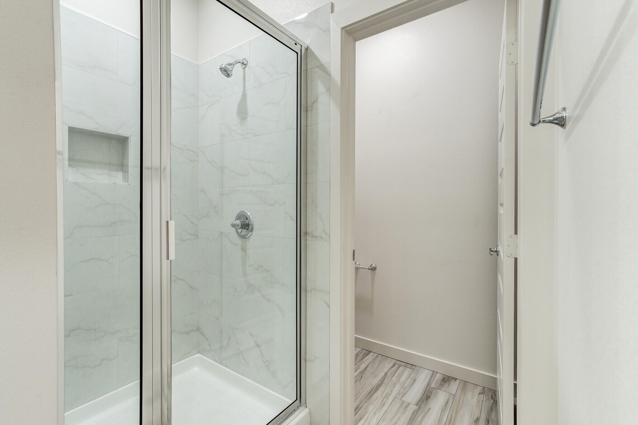 7030 41st Street Lubbock, TX 79407 - Photo 40 of 44 a bathroom with a glass shower door
