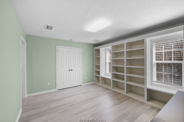 12 Raven's Nest Bryan, TX 77808 - Photo 24 of 46 a view of an empty room with a window and wooden floor