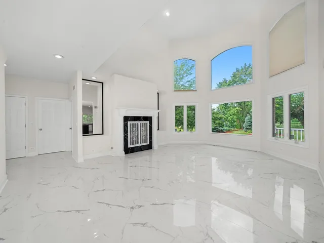 a kitchen with kitchen island granite countertop a stove top oven a sink a counter top space and cabinets