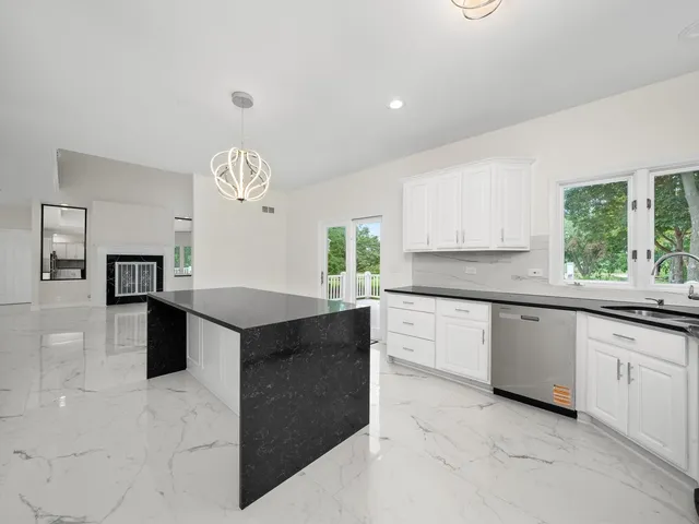 a kitchen with stainless steel appliances a stove a sink a microwave and cabinets