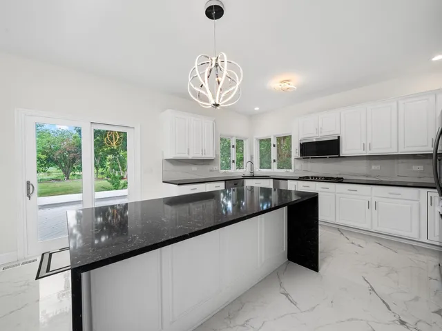 a living room with furniture a bookshelf and a window