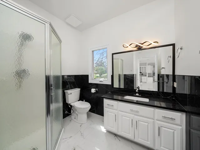 a bedroom with a bed couch and a window