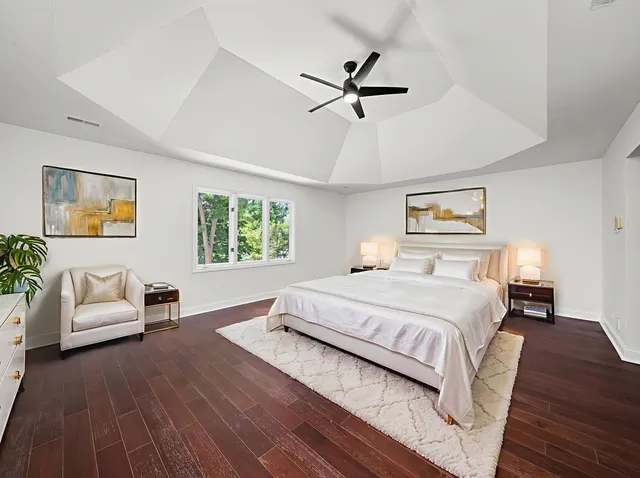 a large white kitchen with a large window