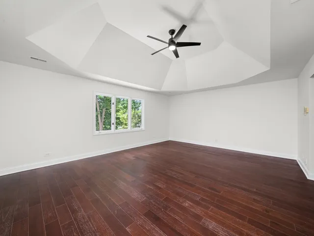 a large hall with stainless steel appliances double vanity and a tub