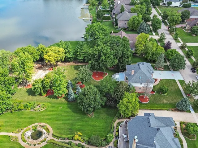 an aerial view of a house with a yard