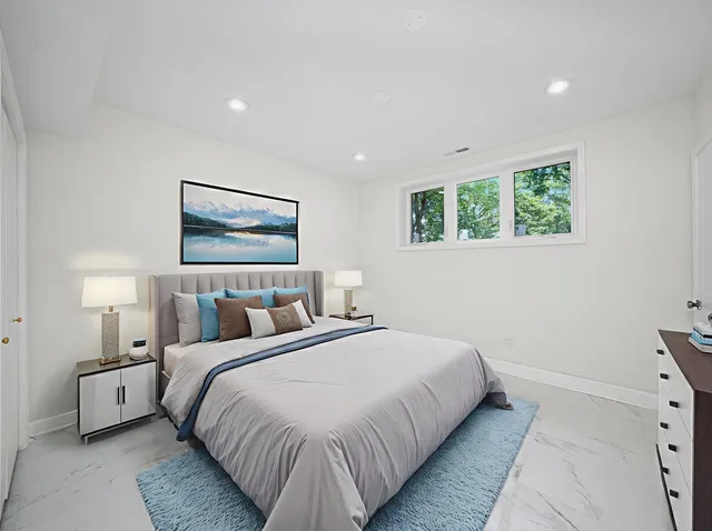 a view of grassy field with benches and trees all around