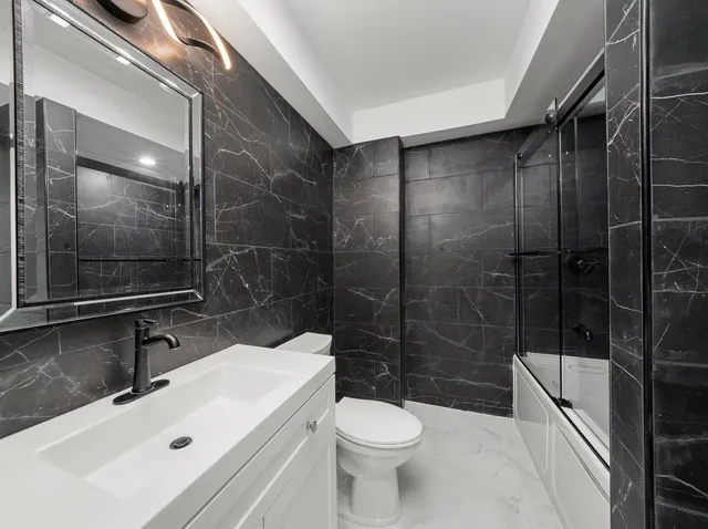 a view of a green field with trees in the background