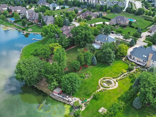 an aerial view of a house with yard swimming pool and outdoor seating