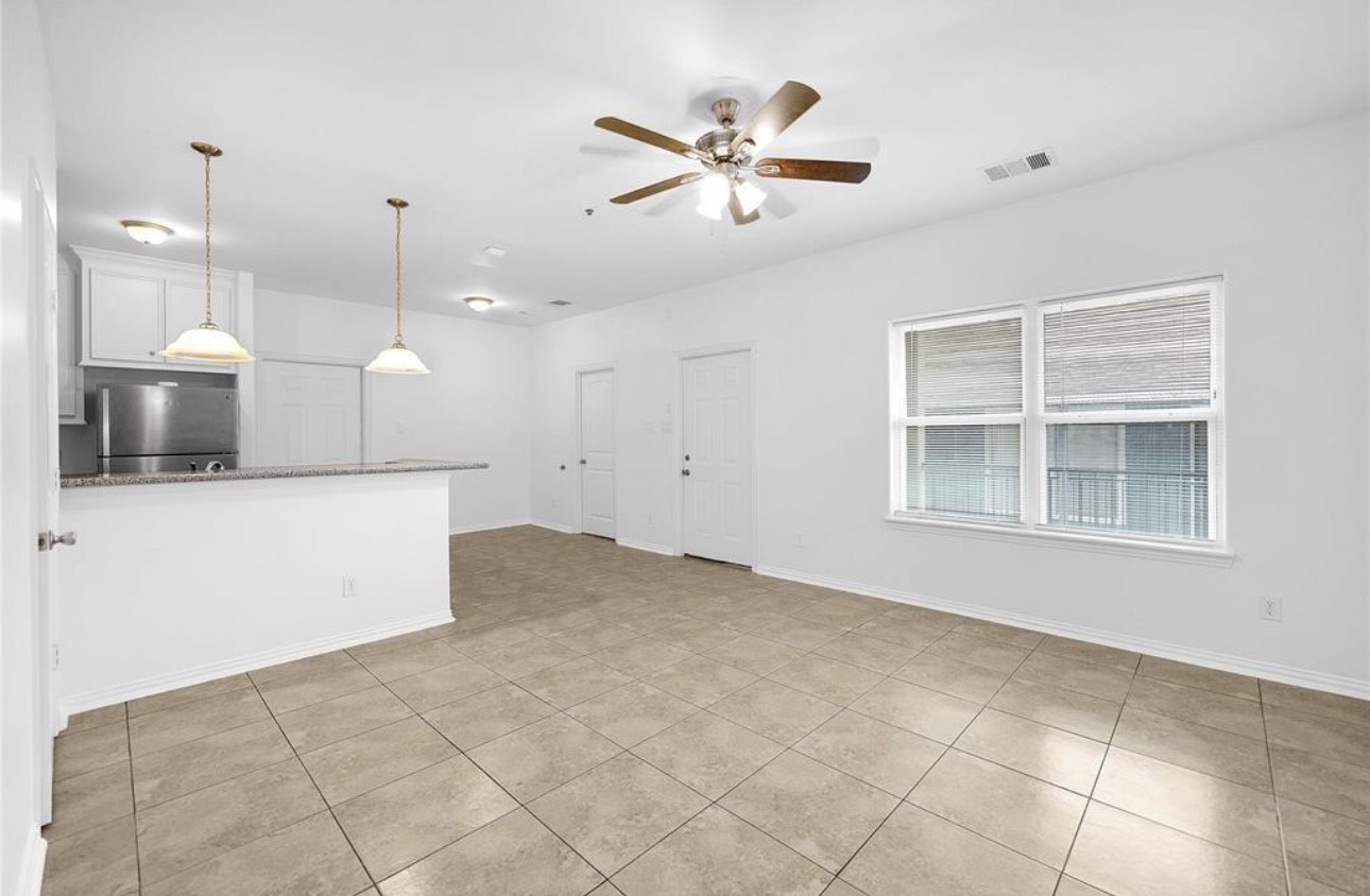 6122 West Mt Houston Road, Unit 4 Houston, TX 77088 - Photo 3 of 11 a view of a kitchen with a stove and a ceiling fan