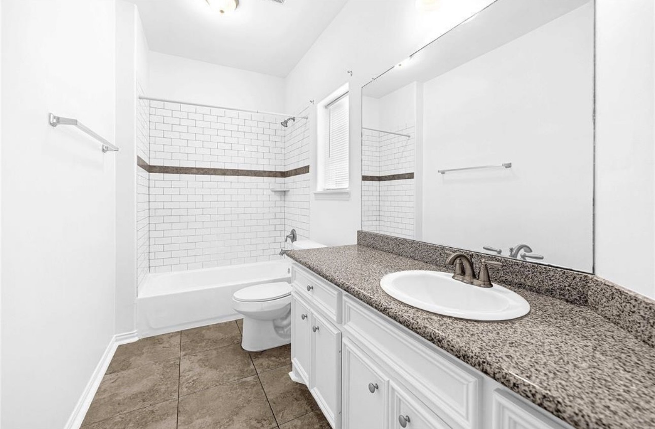 6122 West Mt Houston Road, Unit 4 Houston, TX 77088 - Photo 8 of 11 a bathroom with a granite countertop sink toilet and shower