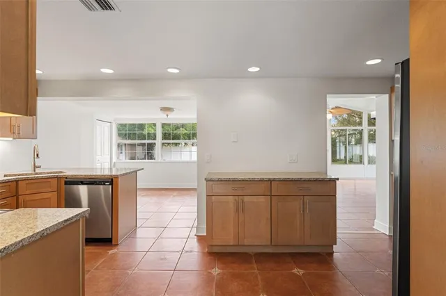 a kitchen with a sink and chairs