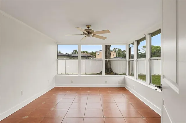 a view of a room with a large window and chandelier