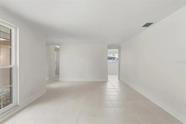 an empty room with windows and entrance