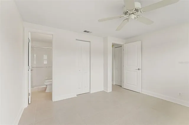 a kitchen with stainless steel appliances kitchen island granite countertop a refrigerator and a sink