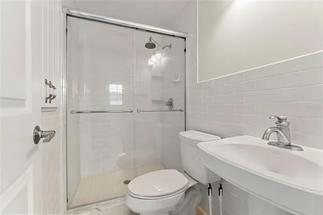 a view of house with a yard and potted plants