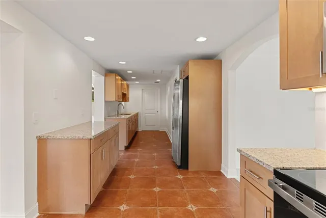 a view of a house with a backyard and a tree