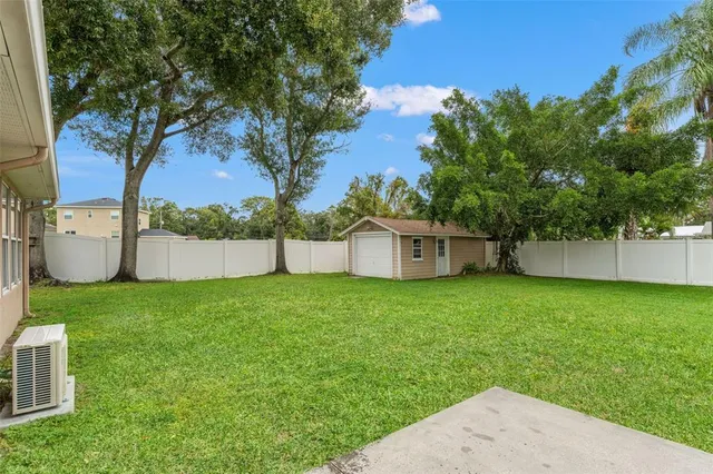 a view of a house with a backyard