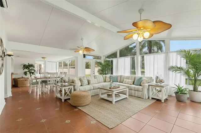 a living room with furniture a chandelier and a large window