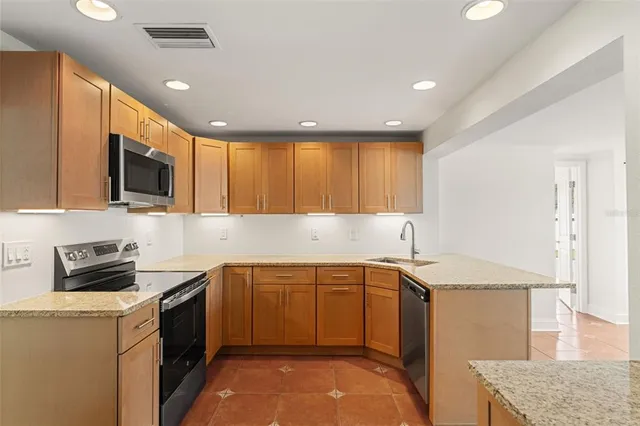 a kitchen that has a sink and a stove in it