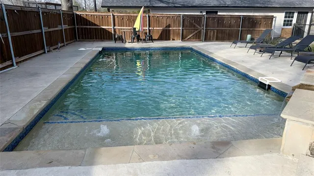 a view of a swimming pool with sitting area