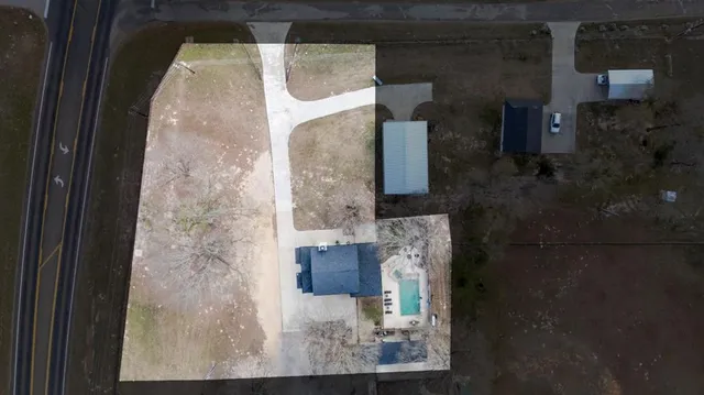 an aerial view of a house with a yard