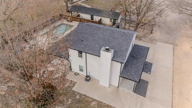 front view of a house with a yard covered with snow