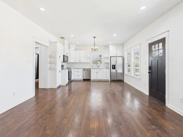a view of kitchen with refrigerator microwave and wooden floor