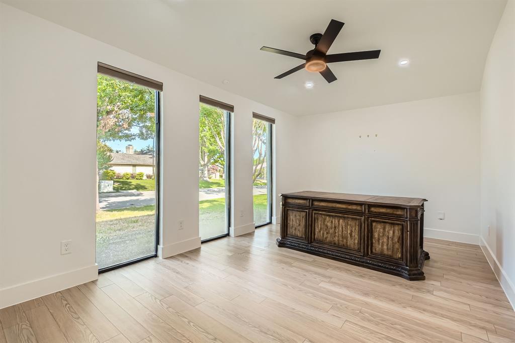 16212 Spring Creek Road Dallas, TX 75248 - Photo 12 of 27 a living room with wooden floor and a window