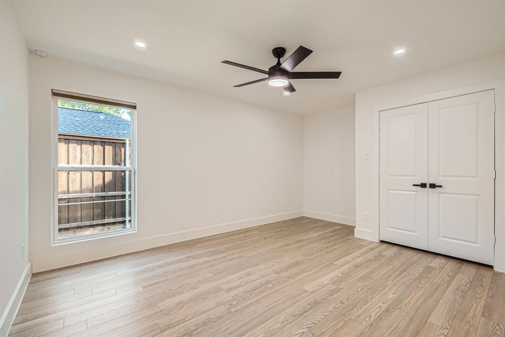 16212 Spring Creek Road Dallas, TX 75248 - Photo 23 of 27 wooden floor in an empty room with a window