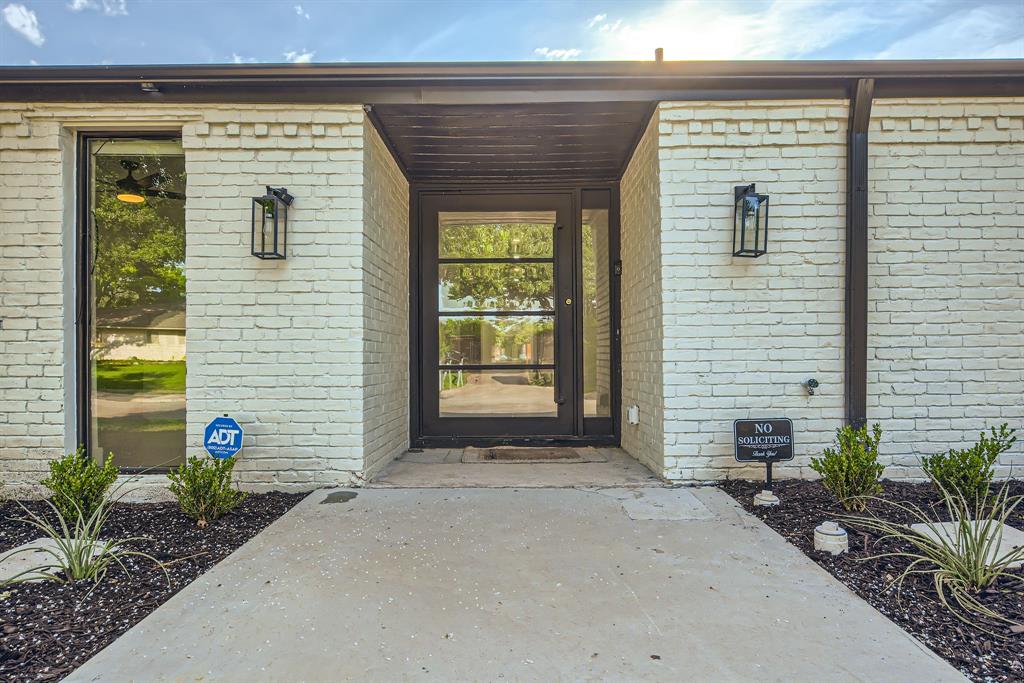 16212 Spring Creek Road Dallas, TX 75248 - Photo 3 of 27 a front view of a house with potted plants