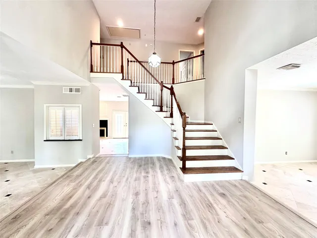 a view of entryway and hall with wooden floor