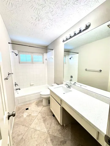 a view of a house with a tree in front of it