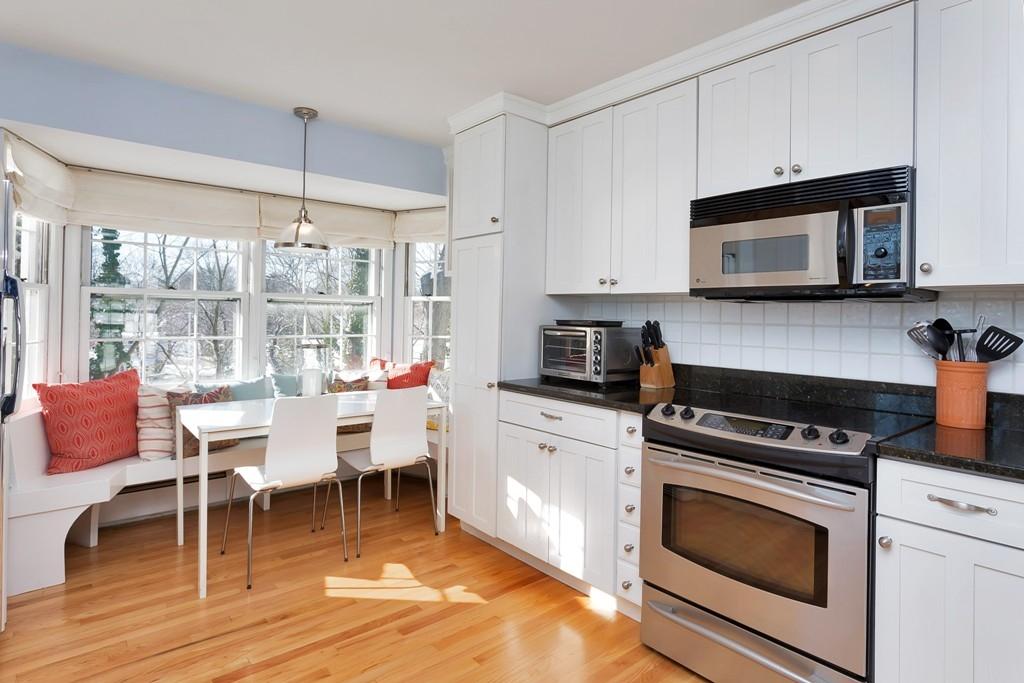 23 Hollow Tree Ridge Road Darien, CT 06820 - Photo 4 of 25 a kitchen with a stove a microwave and wooden floor