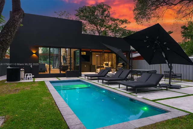 a view of a backyard with sitting area