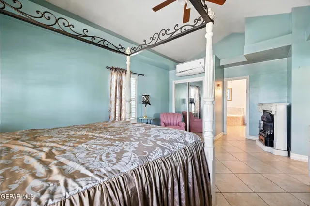 a bedroom with a large bed and a chandelier