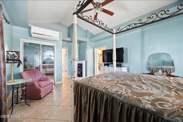 a living room with furniture a chandelier and a fireplace