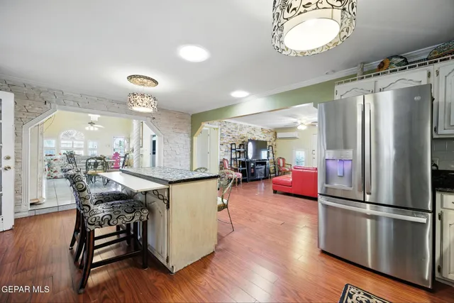 a living room with furniture a couch and kitchen view