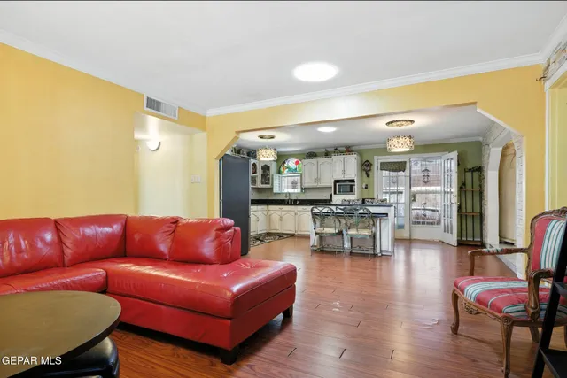 a living room with furniture a couch and kitchen view