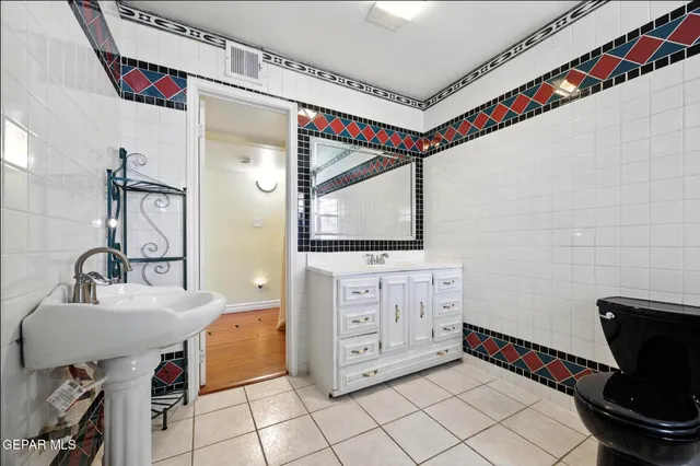 a bathroom with a sink a toilet and mirror