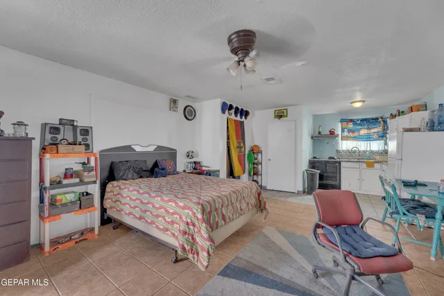 a view of an empty room with a kitchen
