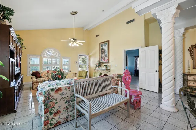 a living room with furniture and a chandelier