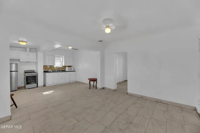 a kitchen with a refrigerator and cabinets