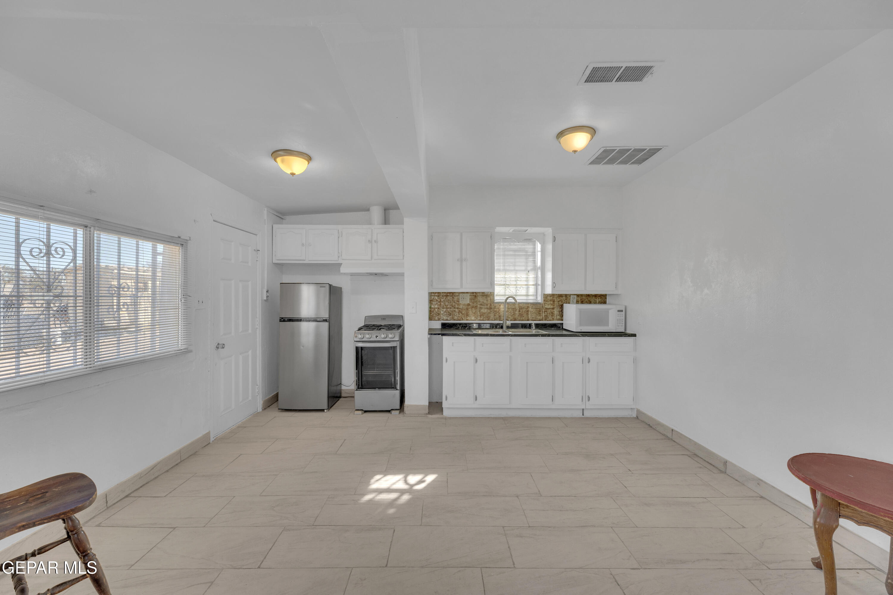190 Polo Inn Road El Paso, TX 79915 - Photo 35 of 58 a large white kitchen with cabinets and a refrigerator