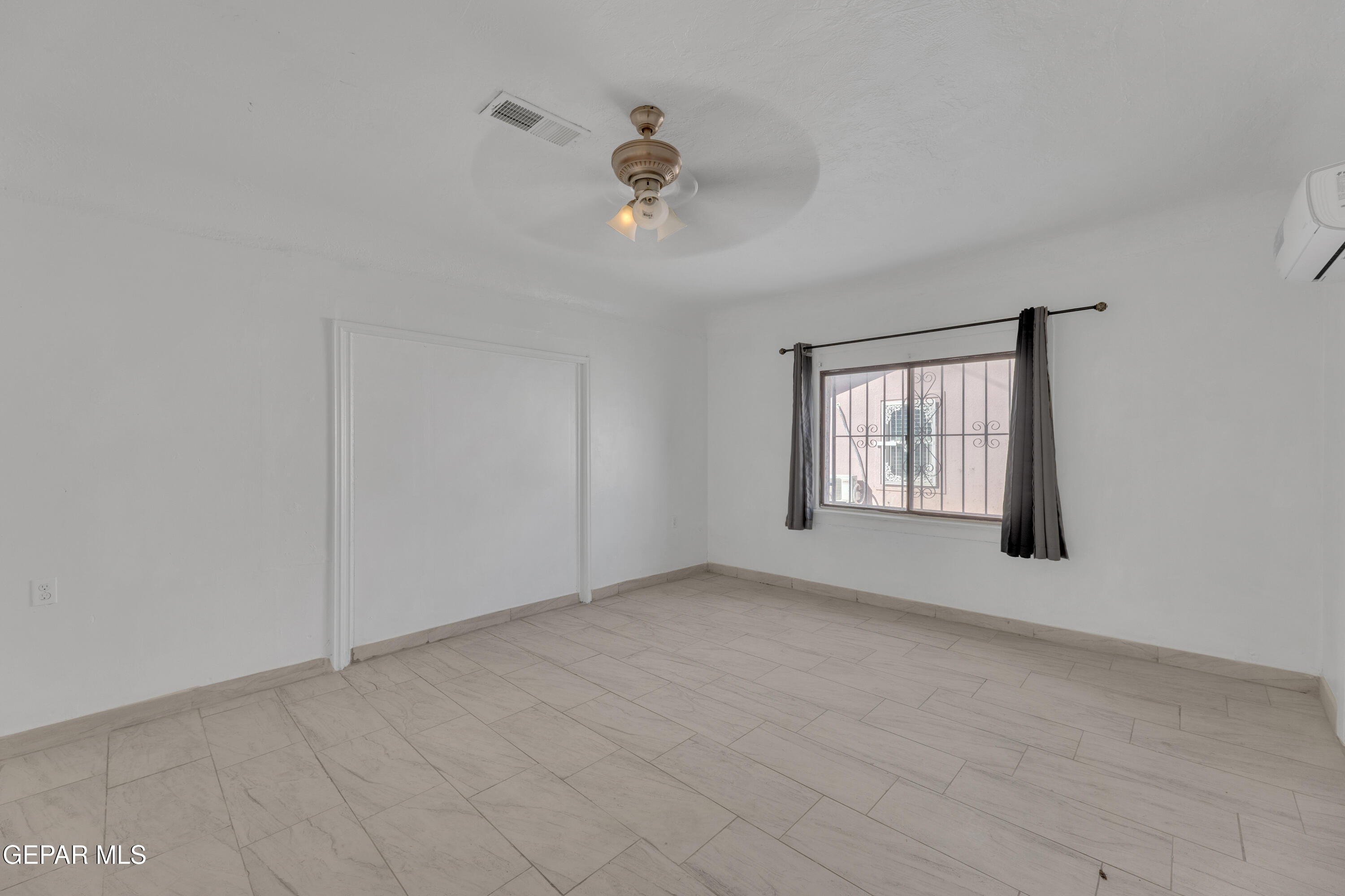 190 Polo Inn Road El Paso, TX 79915 - Photo 44 of 58 wooden floor in an empty room with a window