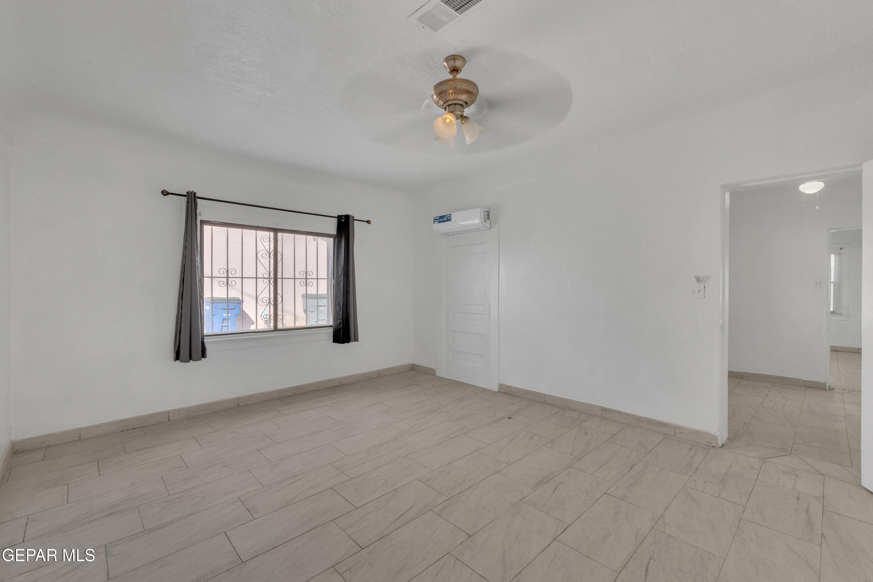 190 Polo Inn Road El Paso, TX 79915 - Photo 45 of 58 wooden floor in an empty room with a window